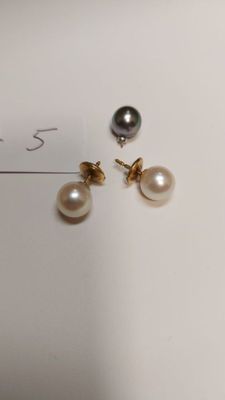 two pairs of pearl and gold earrings on a white surface