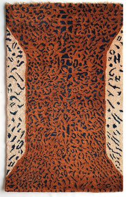 a brown and black rug with a leopard print on it