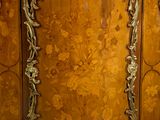 a wooden cabinet with a floral design on it