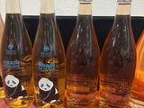 six bottles of wine are lined up in a row on a table