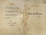 an old book with writing on it sitting on a table