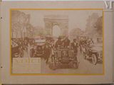 an old photo of a group of people riding in a car down a street