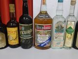 many bottles of alcohol lined up on a table
