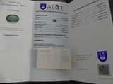 a book with a picture of a green gemstone on it