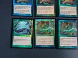 four cards of a card game sitting on top of a table