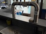 a picture of a kitchen with a sink and a beer tap