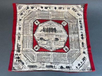 un oreiller rouge et blanc sur lequel est représentée une ville
