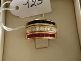a gold ring with a black and red band in a box