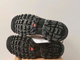 the soles of a pair of running shoes on top of a cardboard box