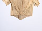 an old shirt hanging on a hanger on a white wall