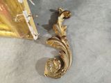 a gold leaf decoration on the wall next to a door