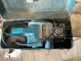 a blue box with a tool in it on the floor