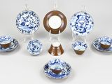 a group of blue and white plates and bowls