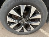 the tire of a car is shown on the pavement