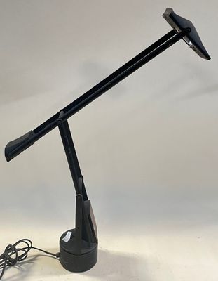 an image of a black desk lamp on a white surface
