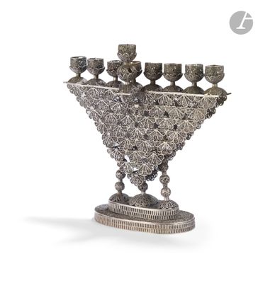 silver plated menorat with five candles and a stand