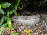 a stone bowl sitting in the middle of the ground
