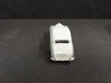 a toy car that is sitting on a black surface