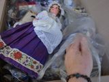 someone is putting a doll in a box with other dolls in it