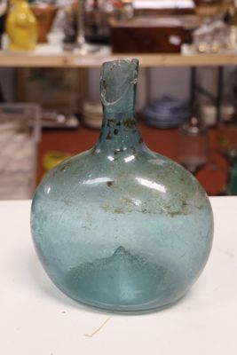 a blue glass bottle sitting on a table in a workshop