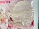 a plastic bag with a dress and a pair of scissors in it