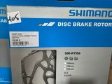 two boxes of shimano disc brake rotors on a table
