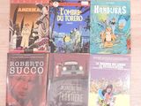 several books on a wooden table with a car in the background