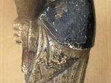 a statue of a woman holding a book on a bed