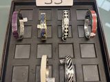 many different bracelets on display in a display case