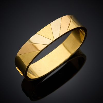 a close up of a gold ring on a black surface