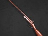 un fusil avec un canon et une crosse en bois, sur fond noir