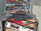 many different tools in a bag on the ground