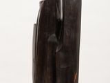 a wooden sculpture on a white surface with a white background