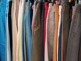 a lot of clothes hanging on a rack in a room