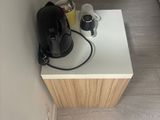 a small table with a coffee maker on it in the corner of a room