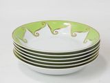 a stack of green and white plates with elephants on them