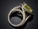 an image of a close up of a ring with a yellow stone