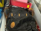 a large black bag sitting on top of a plastic container