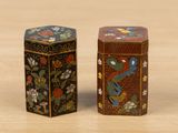 pair of decorative boxes on wooden surface with flowers and birds