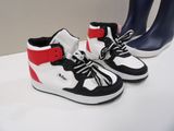 pair of black and white sneakers with red accents on display