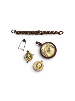 three pieces of jewelry are displayed on a white surface