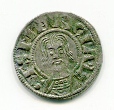 a close up of a coin with a face on it