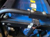 a small blue generator sitting on top of a pile of junk