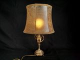 a lamp that is sitting on a table with a black background