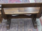 a wooden bench sitting on a rug in a room