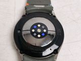 a close up of a watch on a white surface