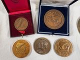 three medals and a medal in a box on a table