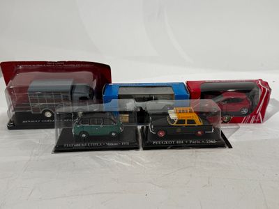 three boxed model buses and a truck in a plastic case