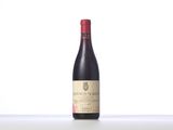 a bottle of red wine sitting on top of a table