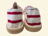 pair of red and white striped espadrills on a white background